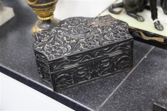 A 19th century serpentine shaped Ceylonese ebonised wood box, 10.75in.